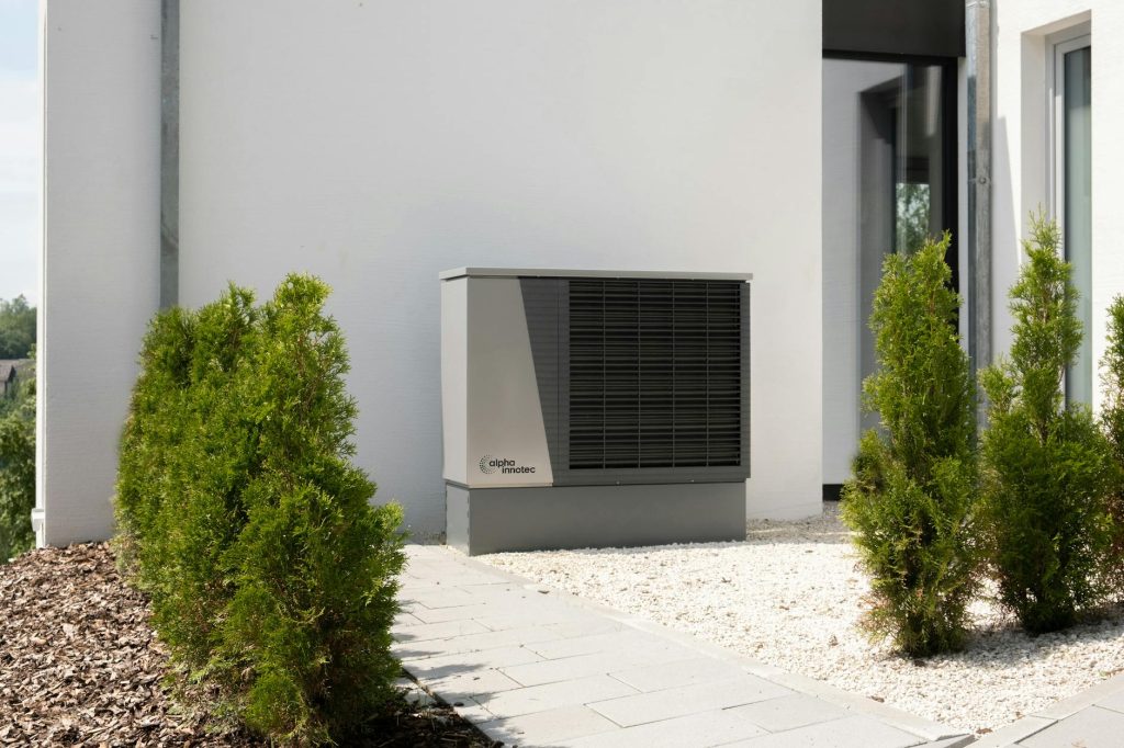 heat pump hot water system Gold Coast - outdoor heat pump unit installed beside a modern home