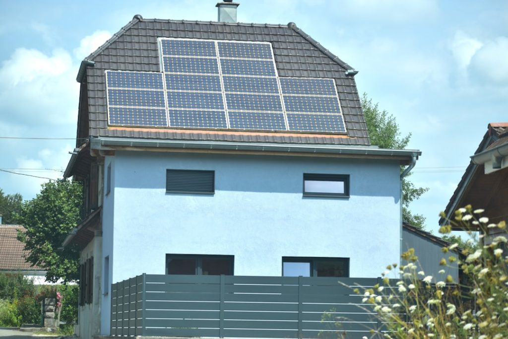 solar hot water system Gold Coast - house roof with solar panels for water heating